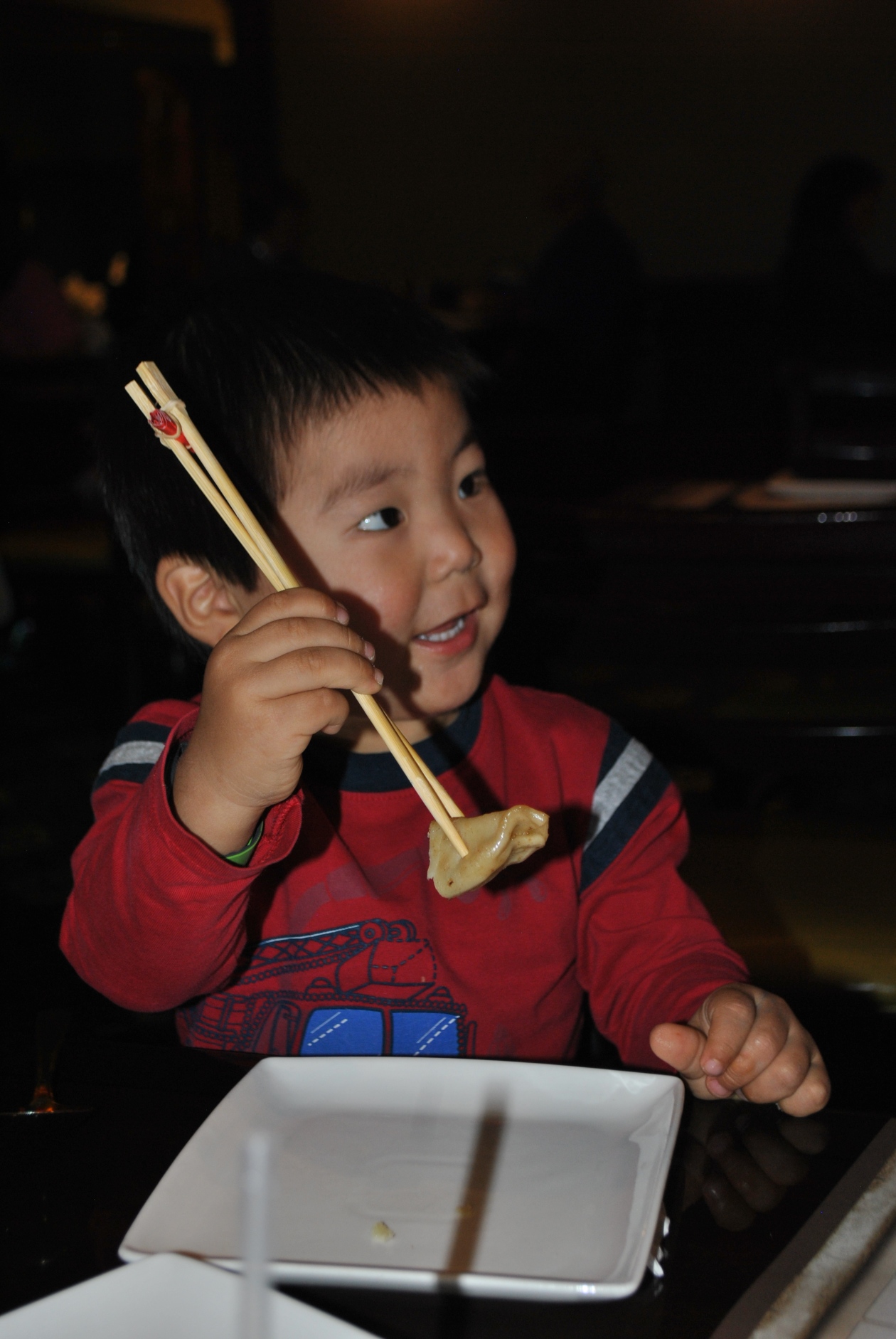 boy eating with chopsticks